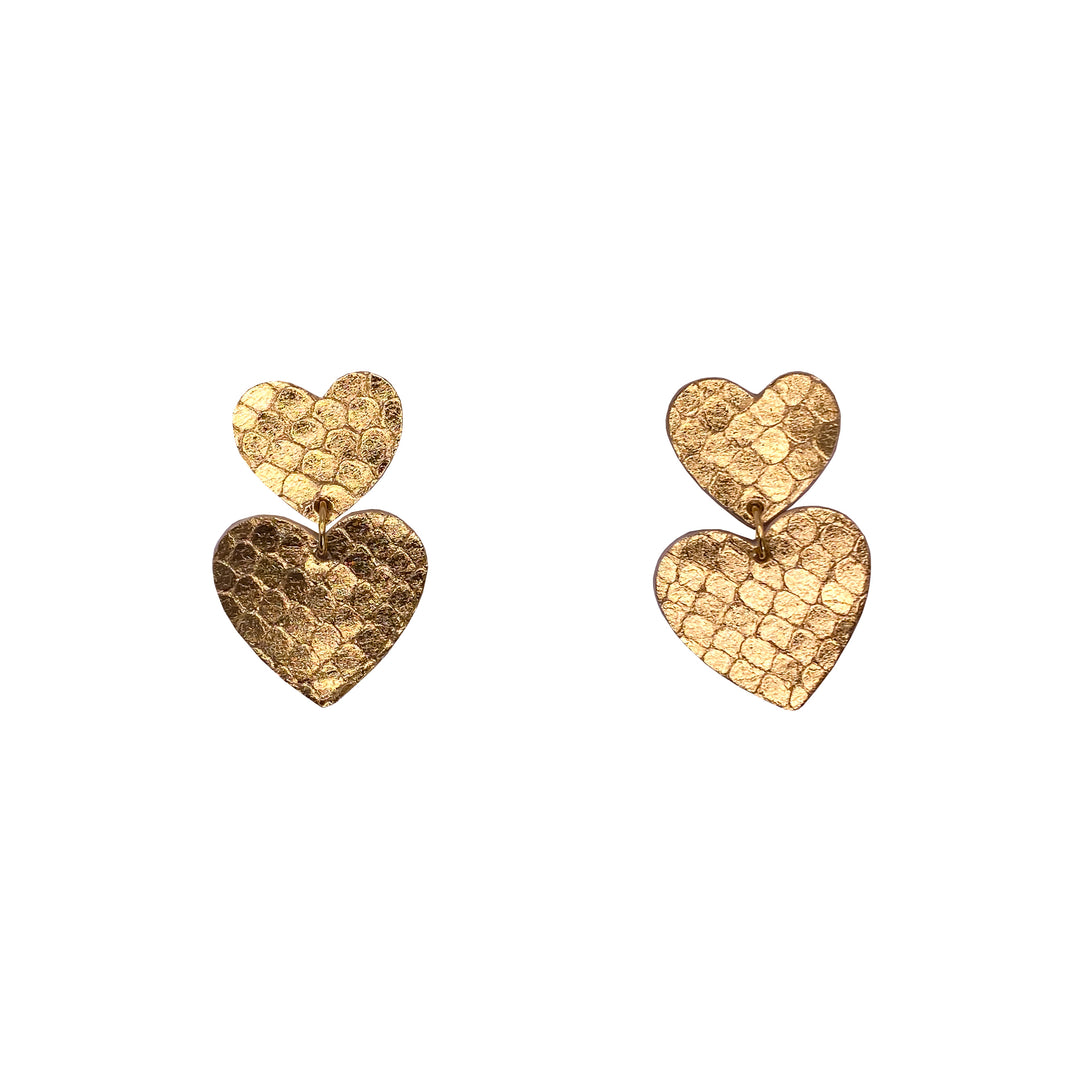 Boucles d’oreilles double cœur en cuir doré texturé serpent, faites main en France par Manali, bijoux artisanaux légers et vibrants.